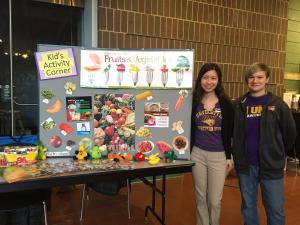 Students with a poster display about fruits and vegetables