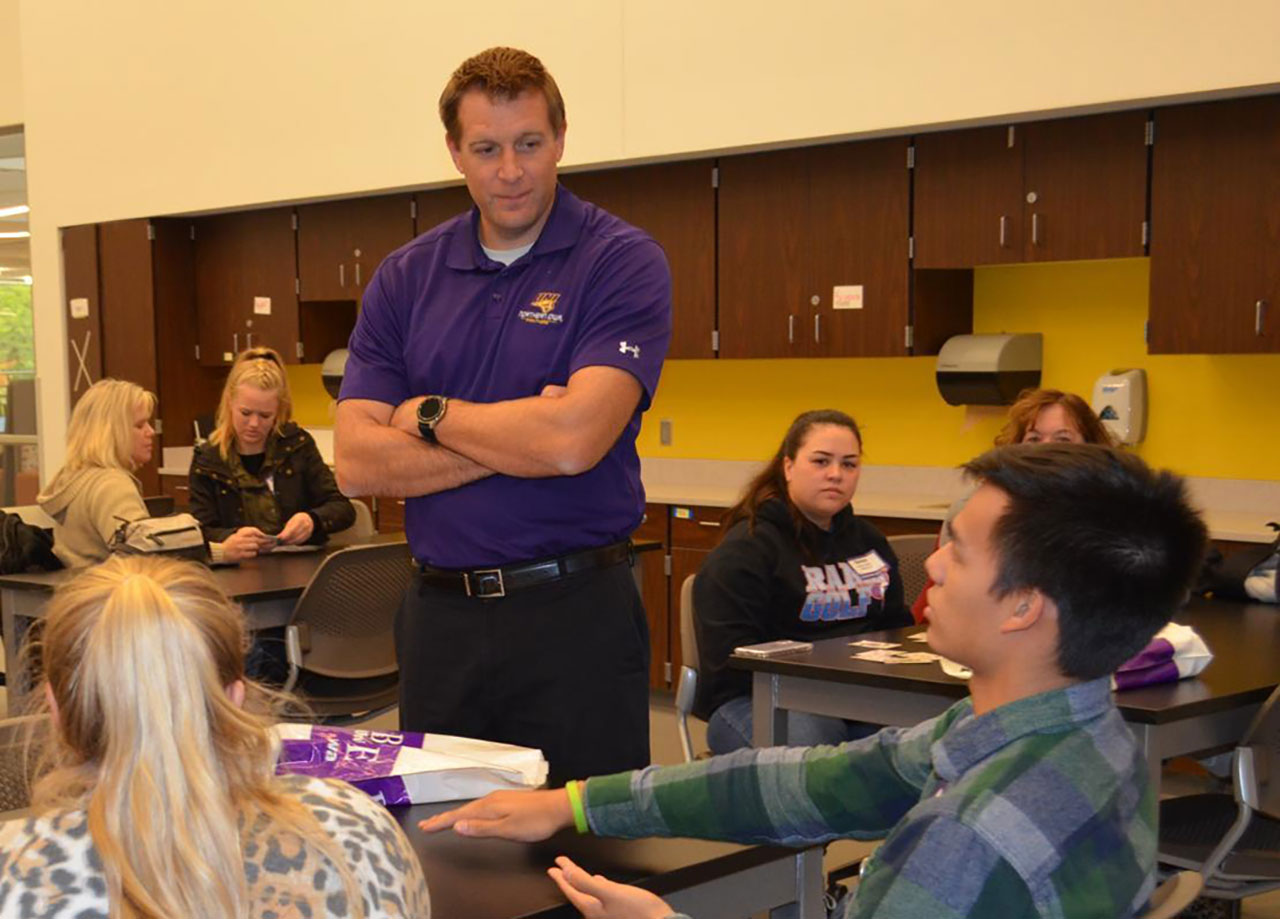 Mason Kuhn in a classroom teaching students.