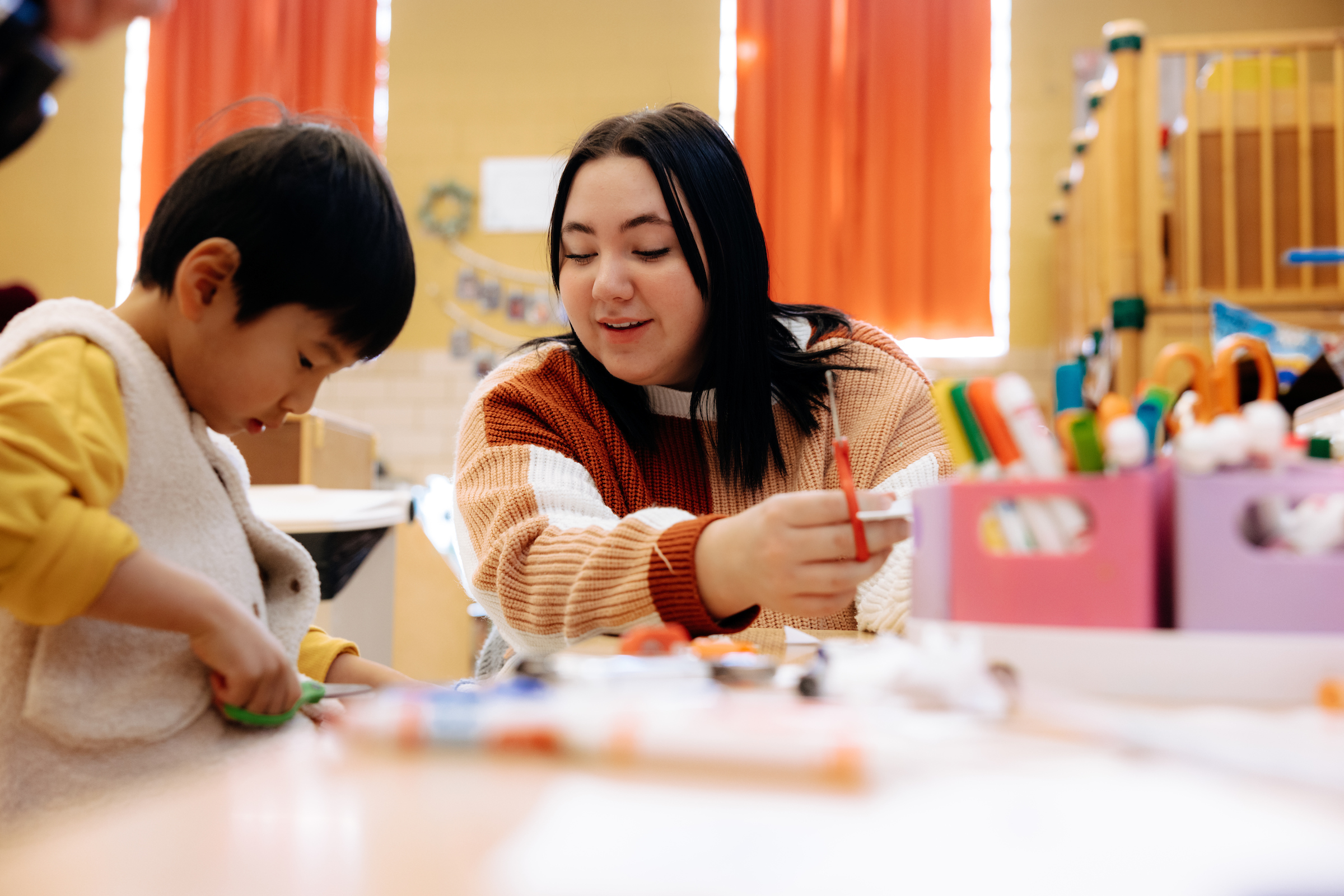 Katelyn working with child at child care center