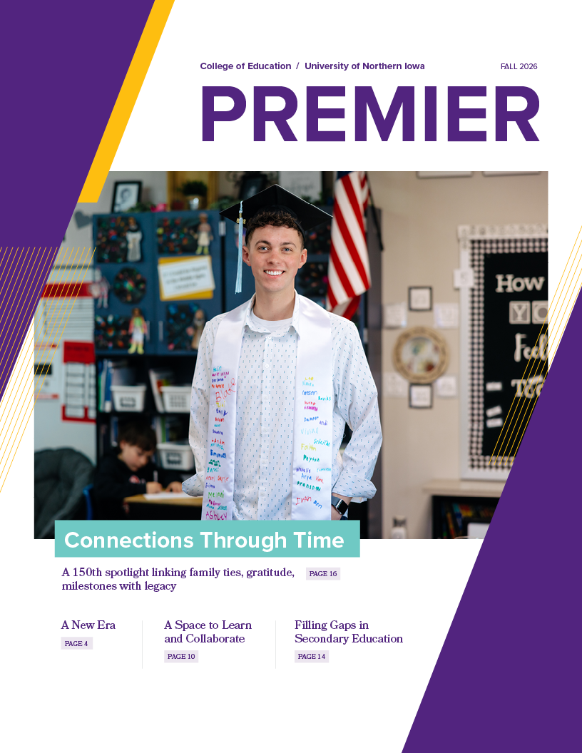 Premier 2026 cover image of male student in graduation garb in classroom