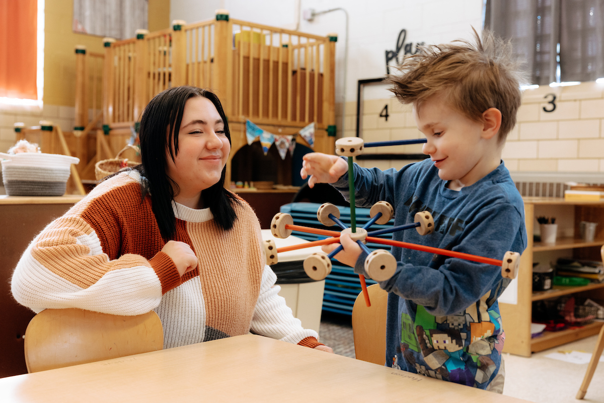 Student teacher working with tinkertoys with five-year-old boy