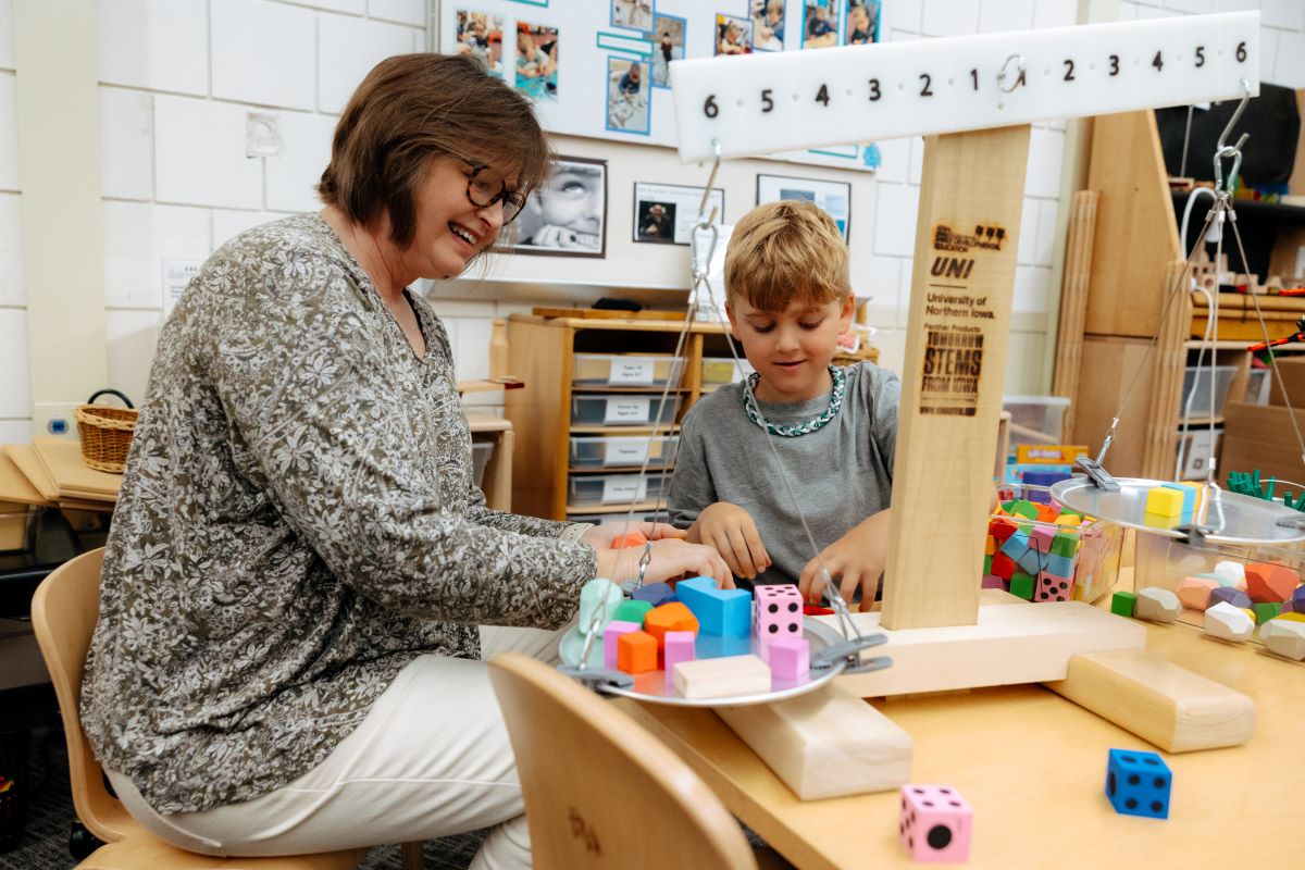 Beth VanMeeteren working with child on the 'All About Balance' learning modules