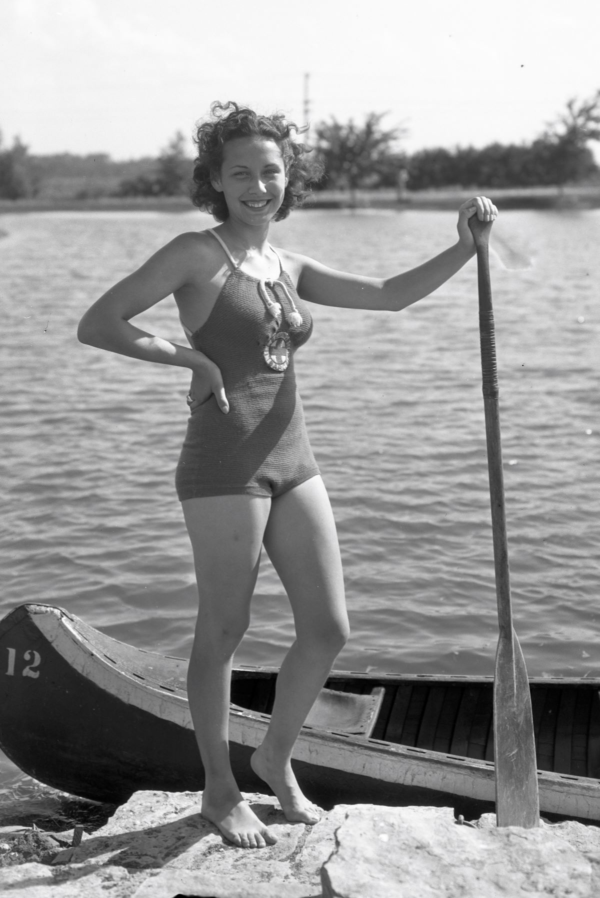 Historical photo of student with canoe