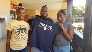 3 University of the Virgin Islands students with a DMACC shirt