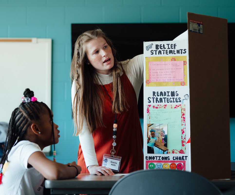 Student with teacher in small study group