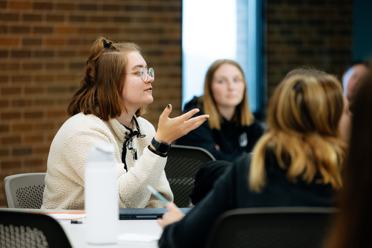 Female student responding in classroom discussion