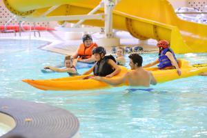 People kayaking in a pool